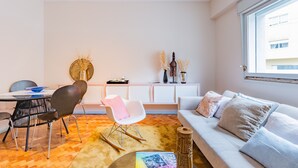 A modern living room with a dining area, white furniture, and a large window. - UNIQUE DUPLEX PENTHOUSE & FREE PARKING (Porto)