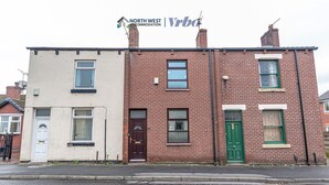 A two-story building with a sign for North West Accommodation. - Spacious 3 Bedroom House in Wigan – Perfect for Contractors & Families (Hindley)