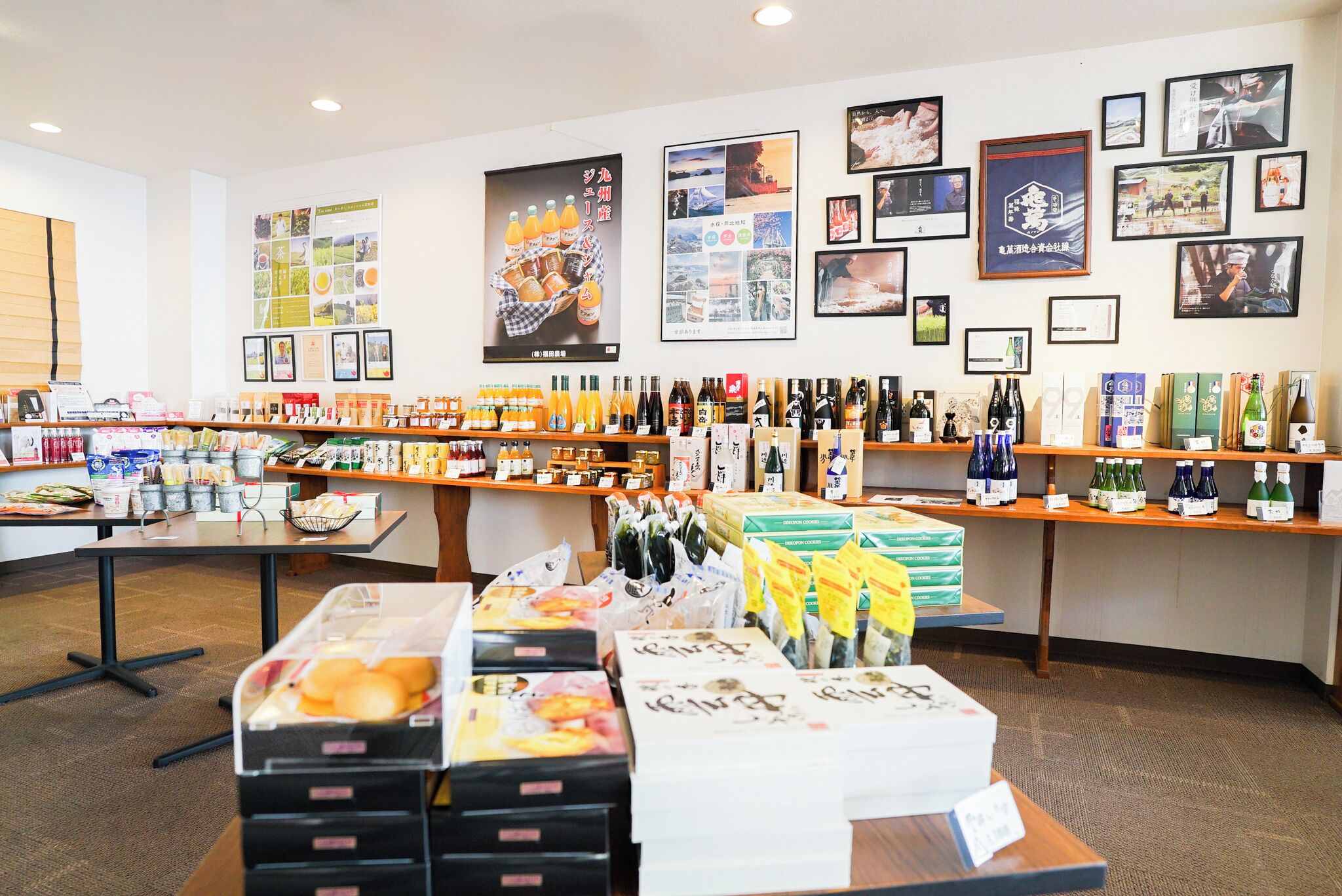 A store with various products on shelves and tables, including bottles and packaged goods.