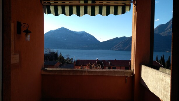 A balcony with a view of a lake and mountains. - Lake view and waterfall view (Bellano)