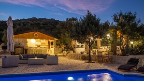 A poolside area with a bar, outdoor seating, and a covered patio. - Etno House Wagner (Peracko Blato)
