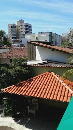 A residential area with terracotta-tiled roofs, a white building, and a tall structure in the background. - Villa Norma Suites (Vitoria)