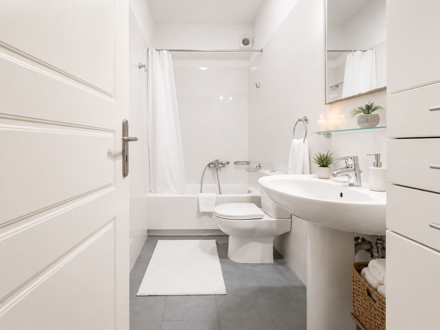 A modern bathroom with a bathtub, toilet, and sink.
