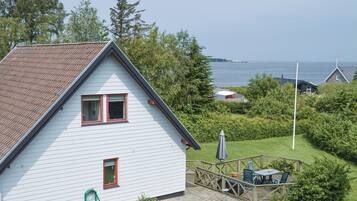 Enjoy waterfront views from this serene property, featuring a deck and lush garden.