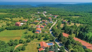 An aerial view of a residential area with houses, roads, and green fields. - Gorgeous home in Krnica (Krnica)