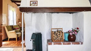 A cozy room with a fireplace, a sofa, and a small table with flowers. - Awesome home in Ryd with house sea view (Ryd)