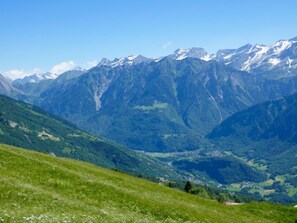 A mountainous landscape with a valley and a clear sky. - Poolside by Interhome (Castro)