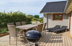 Enjoy al fresco dining on the deck with a grill and comfortable seating.