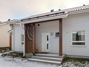 A single-story building with a front door, a small porch with steps, and a mailbox labeled 'B1'.