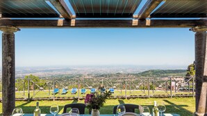 A table set for dining with a view of a cityscape.