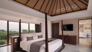 A modern bedroom with a large bed, a wooden ceiling, and a view of greenery. - Royal Suites at The Bandha (Legian)