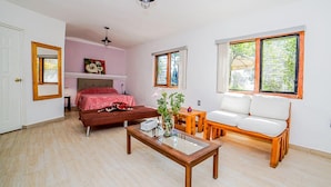 A bedroom with a bed, bedside table, and a window. - Nido de Colibrí Hotel Relax (Salvatierra)