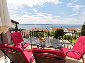 Enjoy a romantic meal for two on this balcony with a stunning view of the water and coastline.