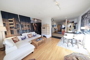 LCD TV, fireplace, books, video library