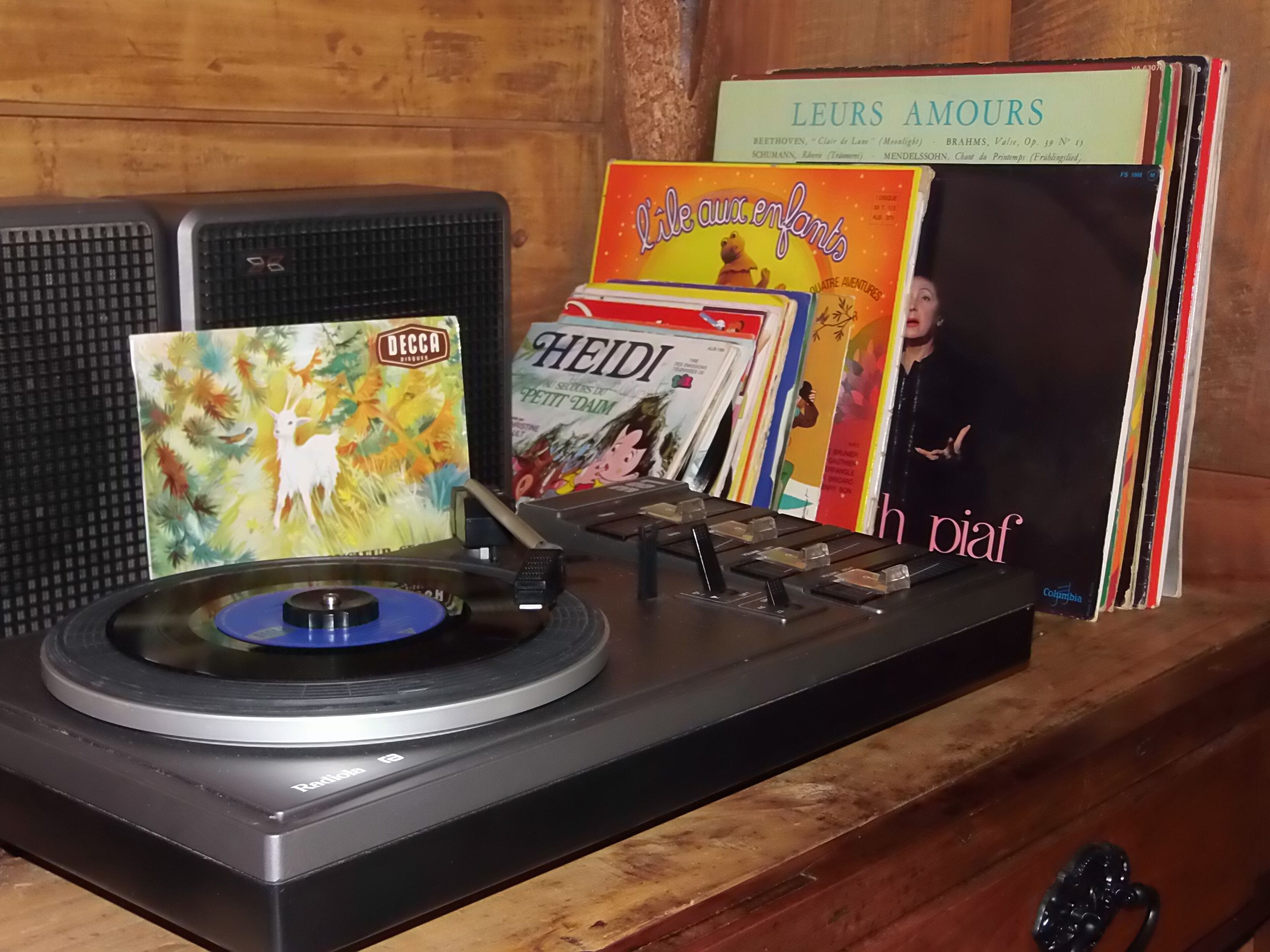 A turntable with vinyl records, a Decca Records album, and a book titled "HEIDI".
