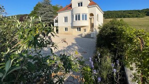 A two-story house with a red roof, a balcony, and a stone foundation. - MAGNIFICENT VIEW HOUSE PARADISIAC IN THE MIDDLE OF VINES OF BOURGOGNE (Rully)