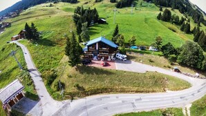 A lodge with a large building, a parking area, and a road curving around the property. - AT THE MOUNTAIN RENTED APARTMENT 5 PEOPLE THE ROC OF THE WIND (Villard-Sur-Doron)