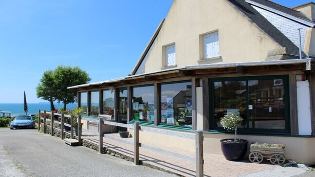 A building with a large glass facade, a wooden deck, and a view of the sea. - panoramic sea view chalet, chalet club 8 (Plomodiern)