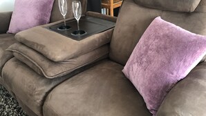 A brown sectional sofa with two purple cushions and a tray table with two glasses. - The lodge "L'Allée du Val" (Lalaye)