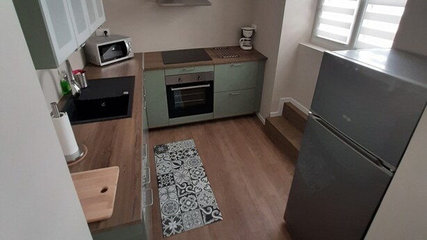 A compact kitchen with a microwave, oven, and refrigerator. - Apartment 101 refurbished !!!! 07/2019 !!!!  45 M2 (sleeps 4)   (Pierrelatte)