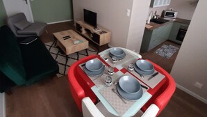 A compact living space with a dining area, a television, and a kitchenette. - Apartment 101 refurbished !!!! 07/2019 !!!!  45 M2 (sleeps 4)   (Pierrelatte)