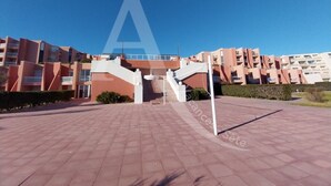 A modern building complex with a central staircase leading to an upper level.