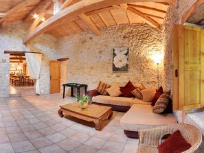A rustic interior with stone walls, wooden beams, a sofa set, a coffee table, and a billiards table. - Charming cottage for 12 people - Wilderness + private pool (Thézac)