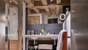 A modern bathroom with a glass shower enclosure, a wooden ceiling, and a built-in sink with a mirror above it. - Lodges - Triplex Prestige N * 4 (Annecy)