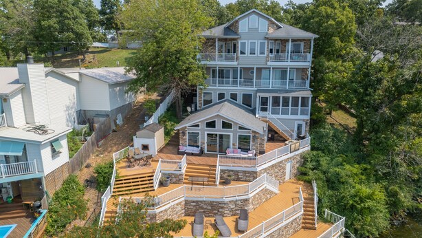 A multi-story house with a deck, a small shed, and a pool. - Giant Lakefront Home with spectacular views of main channel - Lake of the Ozarks (Osage Beach)