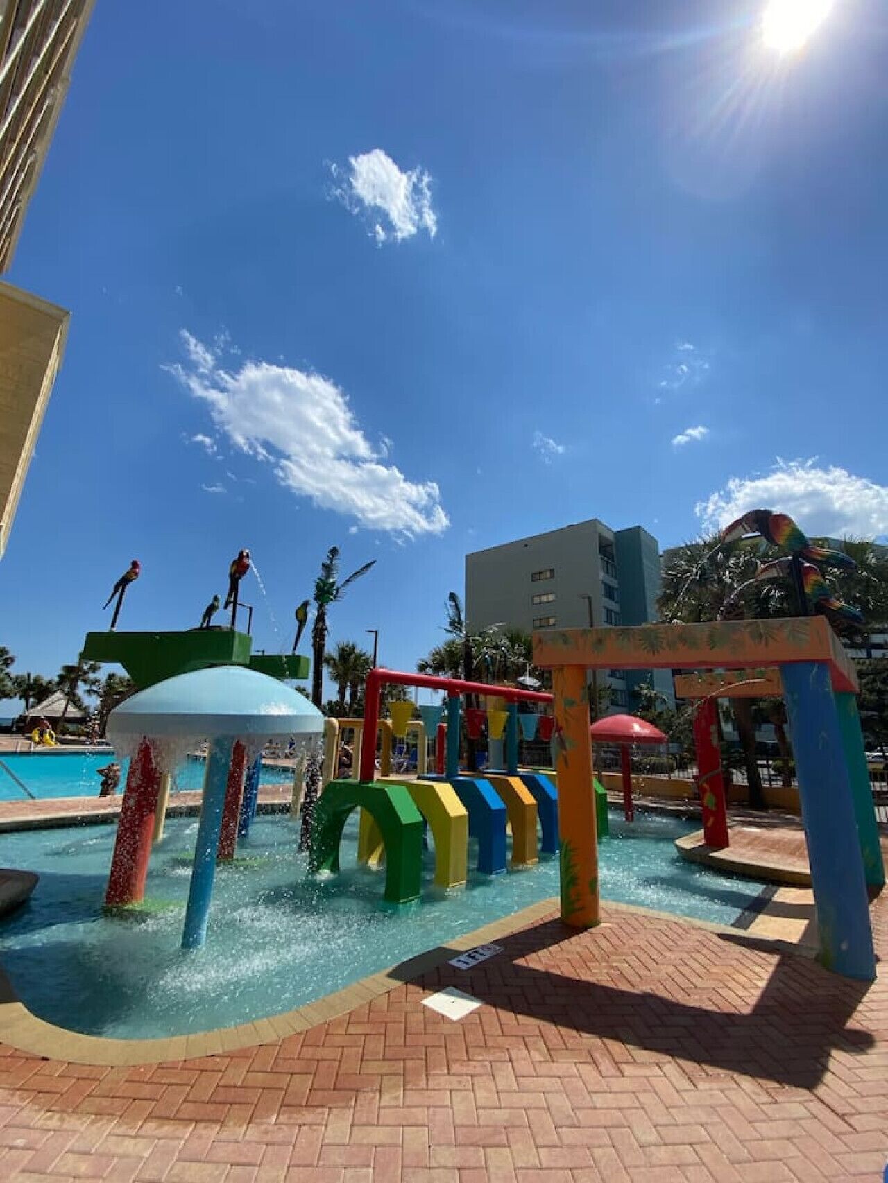 Un parc aquatique avec des jeux colorés et une piscine.