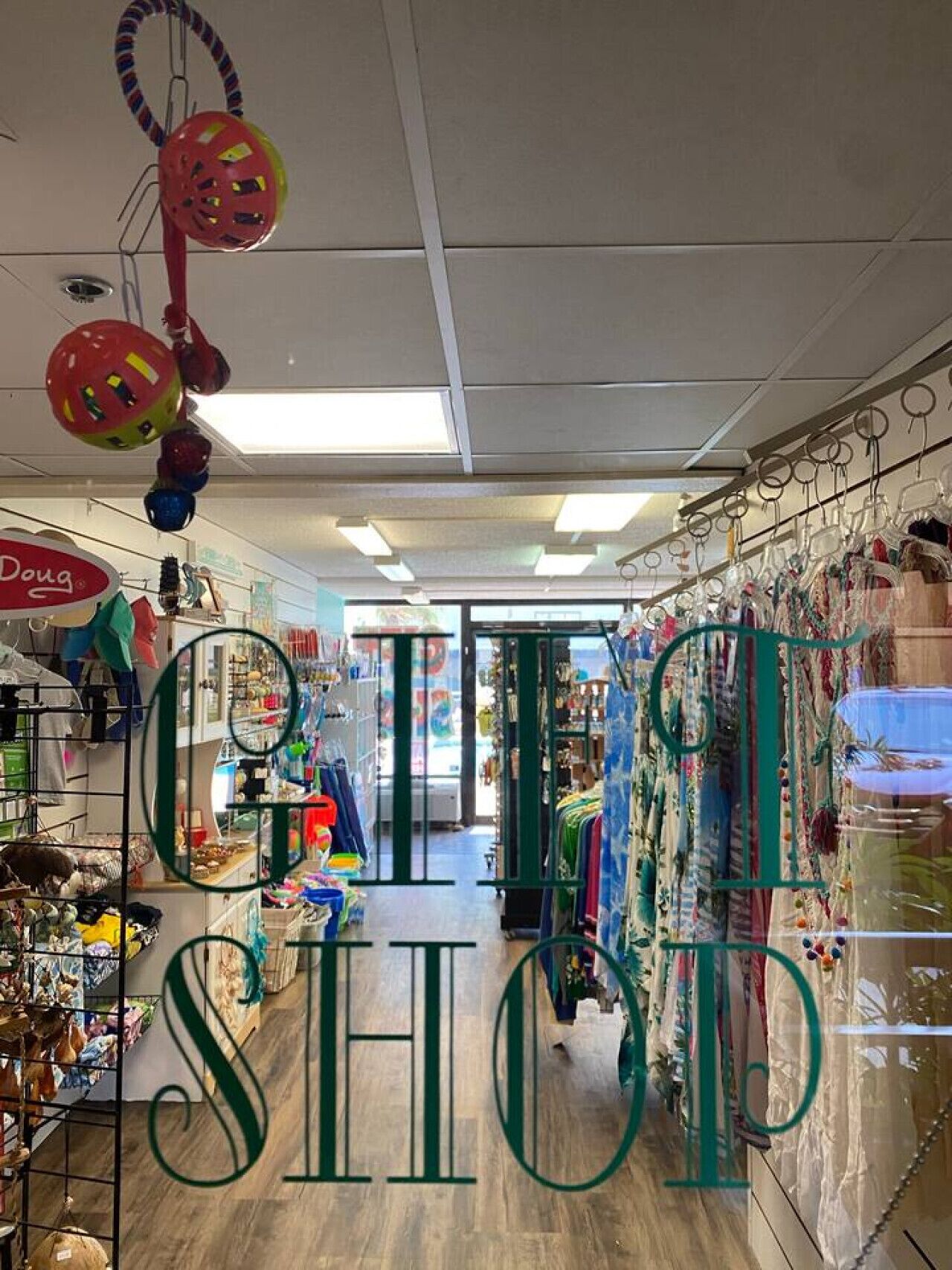 A retail store with various items on shelves and hanging displays, including sports equipment and clothing.