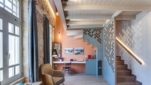 A modern interior with a staircase, a dining area, and a kitchen. - 1924 suites  Terrace (Chania)