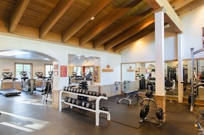 Stay fit on the go with our well-equipped gym featuring treadmills, ellipticals, and a bench press area.