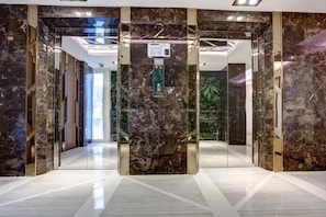 Elevators offer a sleek, polished finish and transparent doors for a clear view of the interior.