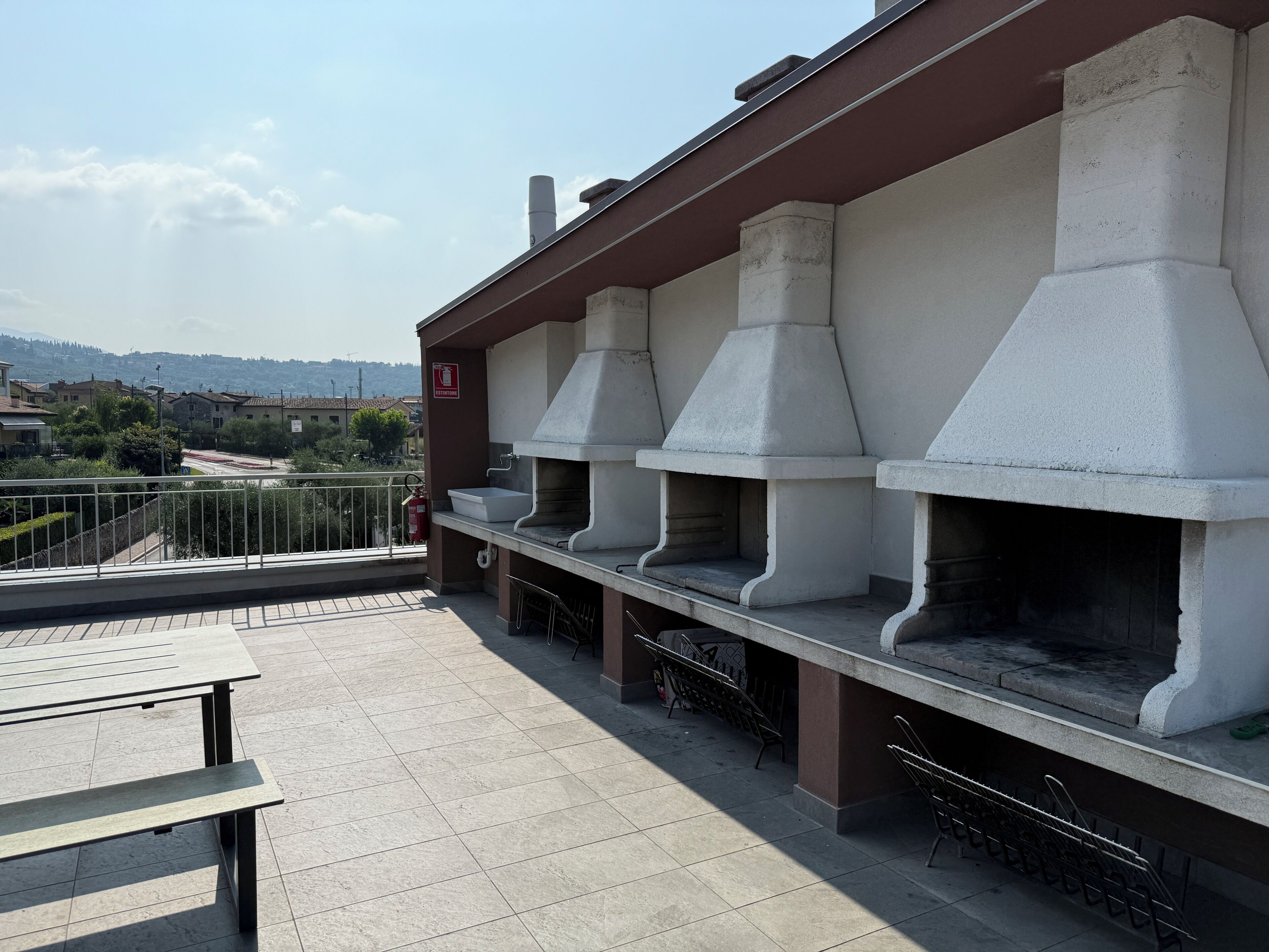 Une terrasse sur le toit avec des espaces de détente en plein air et un coin barbecue.