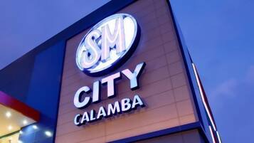 A building with a prominent sign that reads "CITY CALAMBA".