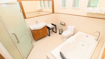 A modern bathroom with a glass shower enclosure, a white sink, a toilet, and a bathtub.