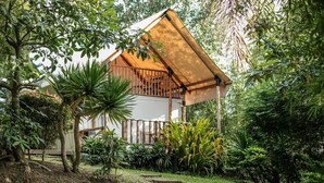 A house with a wooden balcony, surrounded by lush greenery and trees. - The Park - Silang (Silang)