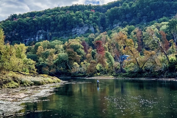 A beautiful fall day captures a fly fisherman in the shoals just below our dock.