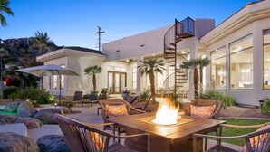 A modern outdoor patio with a fire feature, seating, and a staircase leading to a second floor. - CAMELBACK MT BEAUTY PARADISE VALLEY SCOTTSDALE AREA (Paradise Valley)