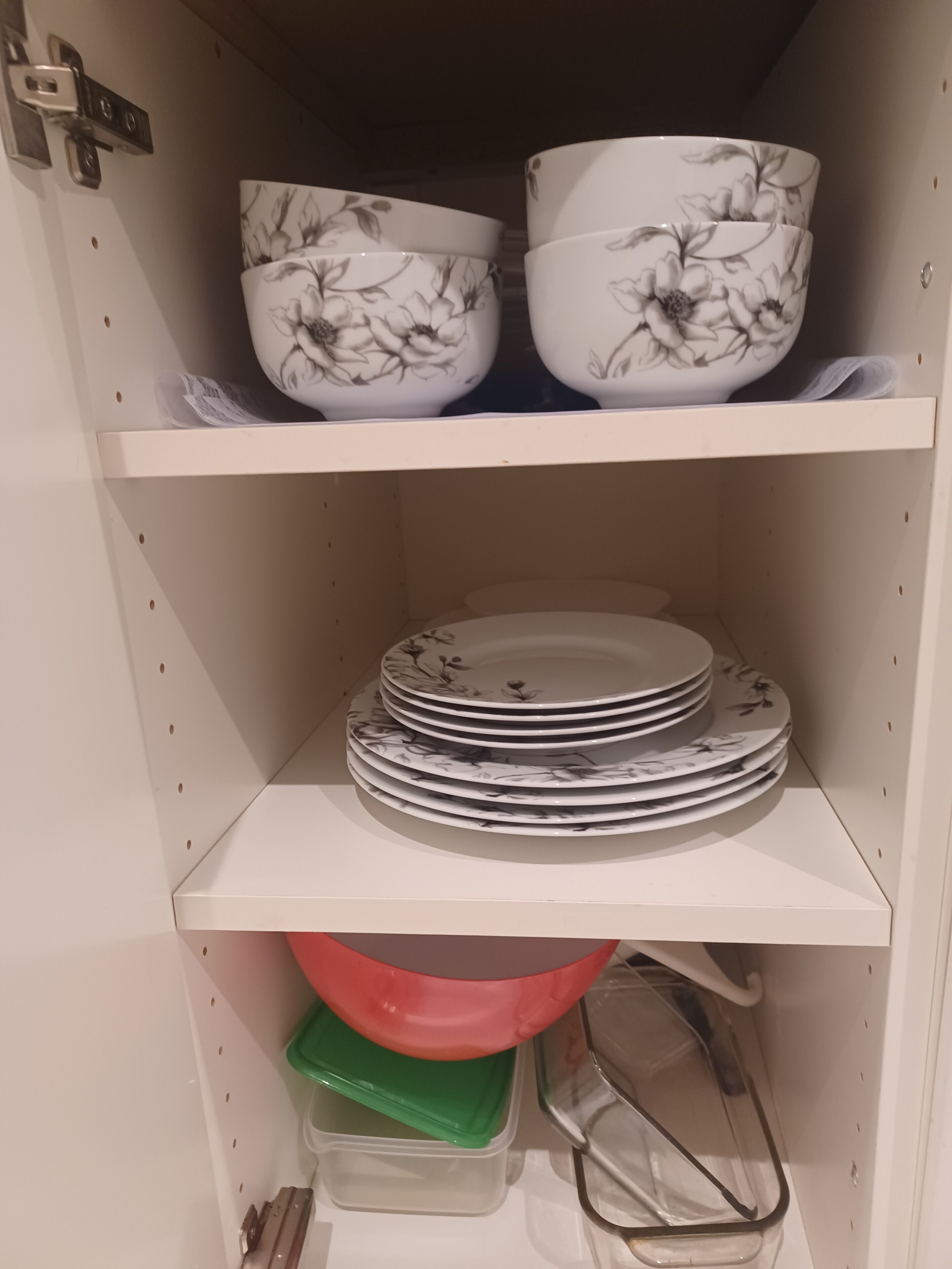 A shelf with stacked plates and bowls.