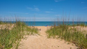 A sandy beach with tall grass in the foreground leading to the ocean. - Beachfront Home- Amazing Oceanfront w/ Hot tub!!! Sleeps 8- Free Wifi! -6 beds (Kill Devil Hills)