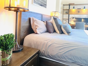 Relax in comfort with a large bed, desk, and ample workspace.