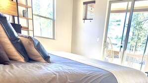 A bedroom with a bed, a window, and a plant. - Stunning New Contemporary Home Minutes to Downtown Flagstaff (Flagstaff)