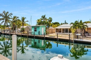 A marina with a calm water body, small houses, and palm trees. - Waterfront Marathon FL Keys Home w/ Private Dock (Marathon)