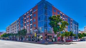 A multi-story building with a modern architectural design, featuring large windows and balconies.