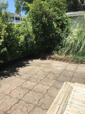 A paved patio area with a wooden deck in the foreground. - Close to beach, Pet friendly, Golf cart (Myrtle Beach)
