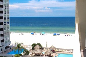 A hotel with a pool, beach view, and thatched umbrellas. - Beachside Bliss! 3/3, Heated Pool/Hot Tub 501 (Redington Shores)