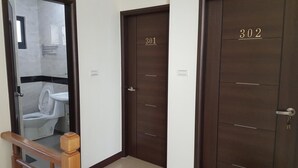 A hallway with three doors, numbered 301, 302, and another door with a number not visible. - Fishmoon Homestay (Magong)