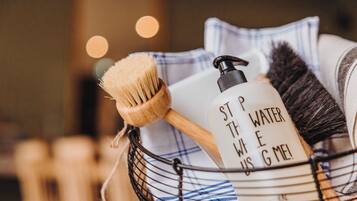 A bathroom sink with a wooden brush and a soap dispenser with a motivational message.